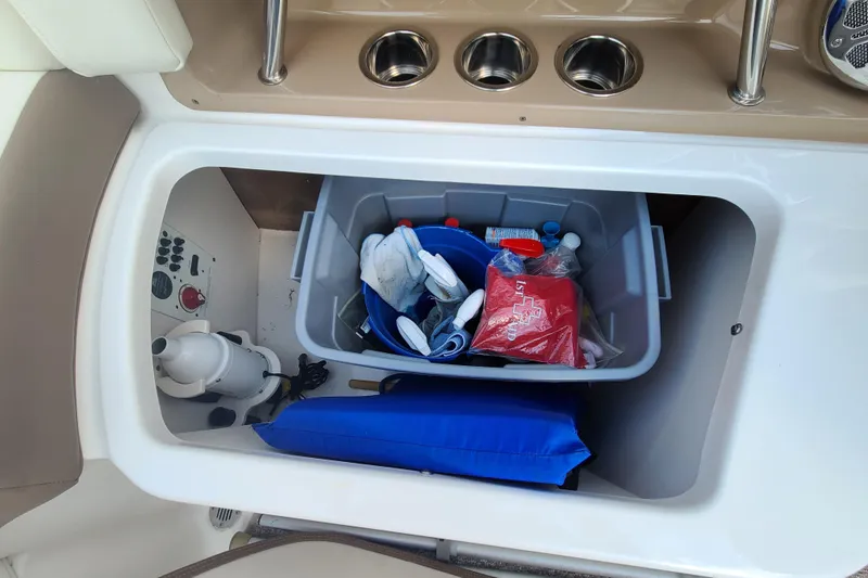 Slide: The Image of Storage compartment in a 2014 Chaparral 246 SSi boat with safety and utility items. - 27