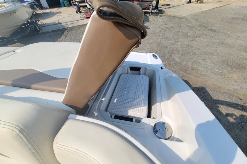 Slide: The Image of 2014 Chaparral 246 SSi boat with open storage compartment and cooler. - 29