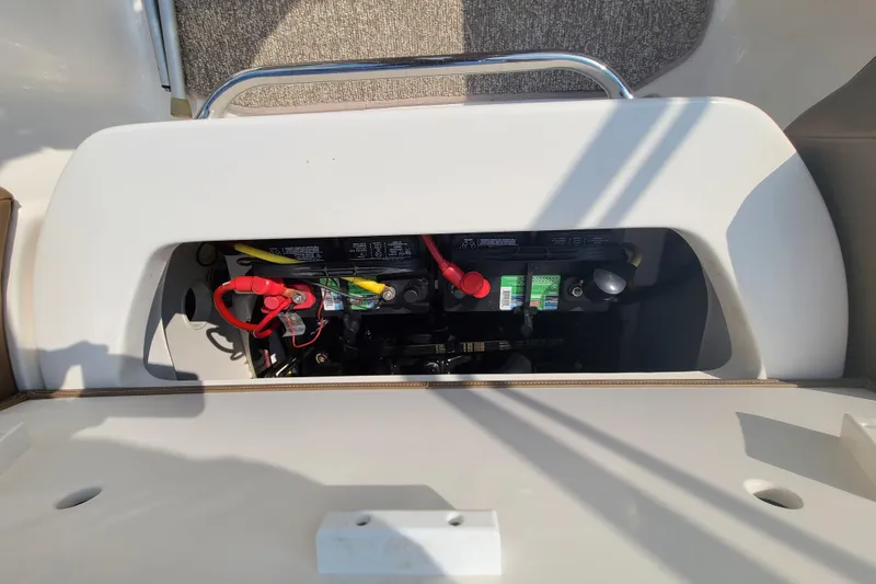 Slide: The Image of Battery compartment of a 2014 Chaparral 246 SSi boat, showing wiring and connections. - 33