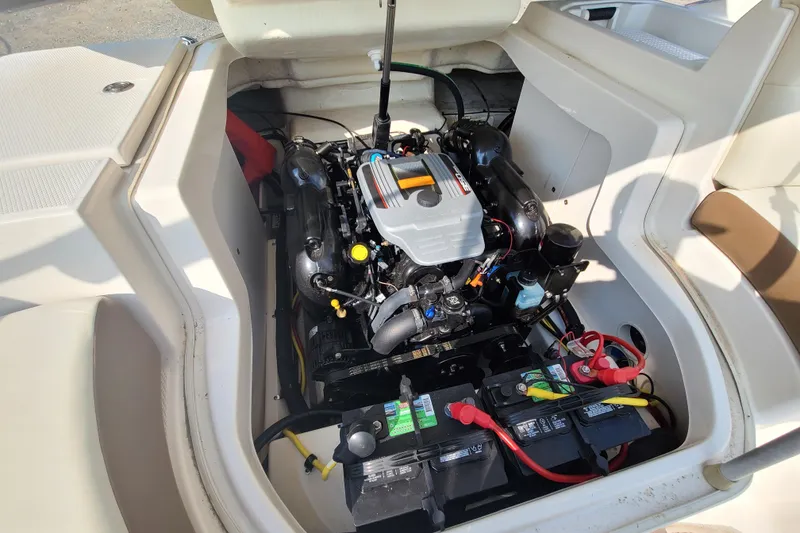 Slide: The Image of Engine compartment of a 2014 Chaparral 246 SSi boat, showcasing the engine and batteries. - 34