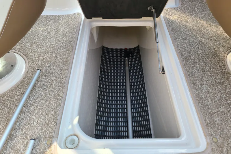 Slide: The Image of Storage compartment in 2014 Chaparral 246 SSi boat with carpeted flooring and hydraulic lift. - 37