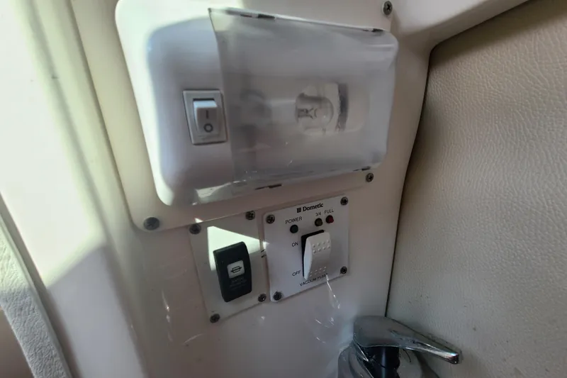 Slide: The Image of Control panel and light switch on a 2014 Chaparral 246 SSi boat. - 39