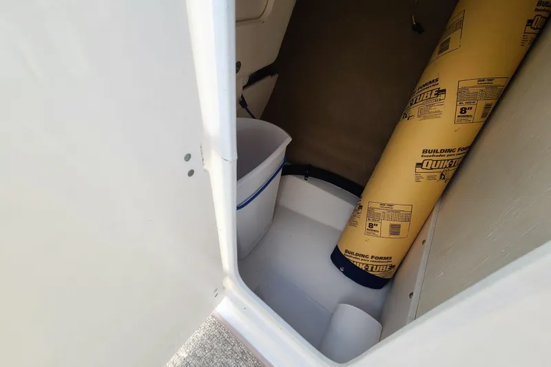 Slide: The Image of Storage compartment in a 2014 Chaparral 246 SSi boat with building materials. - 41