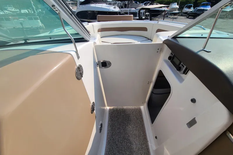 Slide: The Image of 2014 Chaparral 246 SSi boat interior with open compartment and seating area. - 42