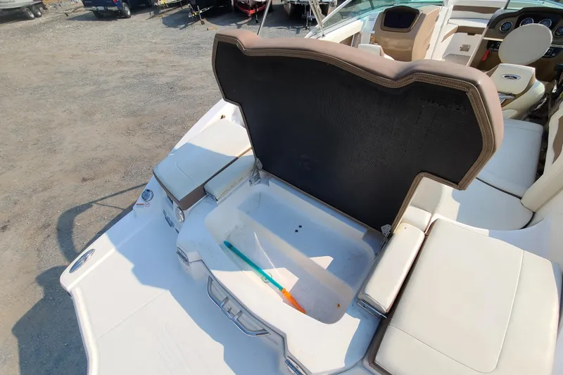Slide: The Image of 2014 Chaparral 246 SSi boat interior with open storage compartment. - 43