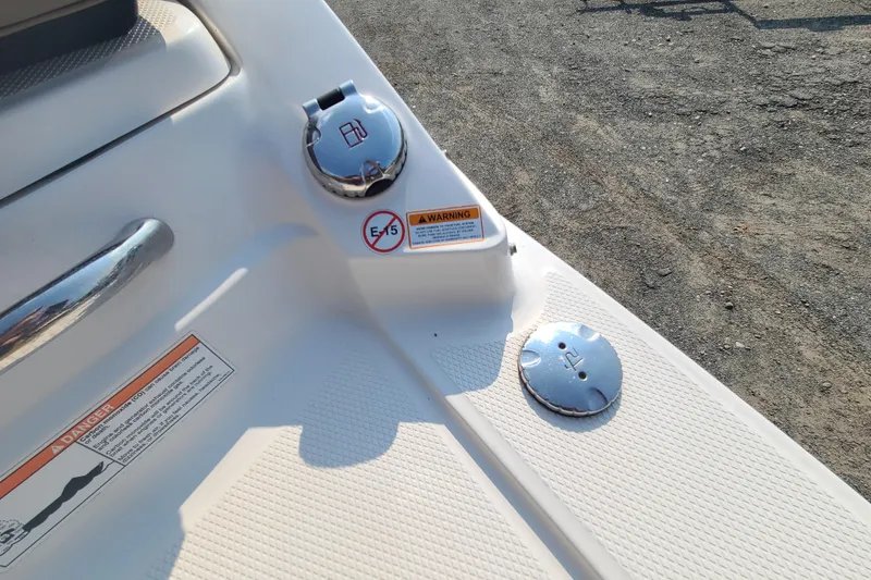 Slide: The Image of 2014 Chaparral 246 SSi boat fuel cap and warning labels on deck. - 44