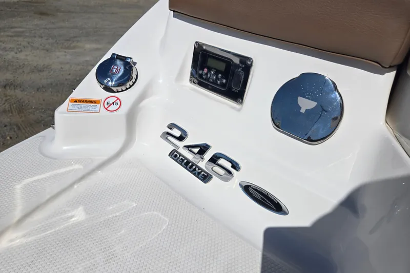 Slide: The Image of 2014 Chaparral 246 SSi boat dashboard with controls and warning labels. - 46