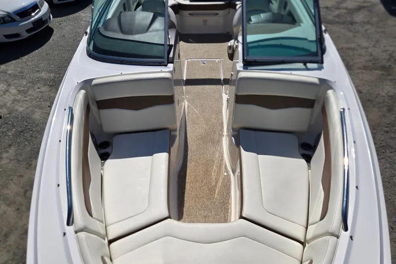 Slide: The Image of 2014 Chaparral 246 SSi boat interior with white seating and open windshield. - 52