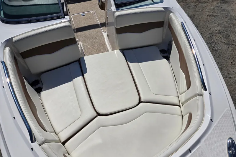 Slide: The Image of 2014 Chaparral 246 SSi boat interior with white cushioned seating. - 53