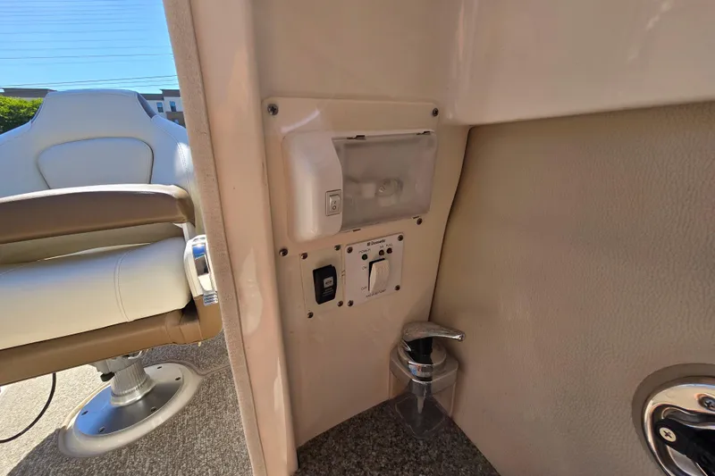 Slide: The Image of Interior view of a 2014 Chaparral 246 SSi boat, featuring a control panel and seating. - 57