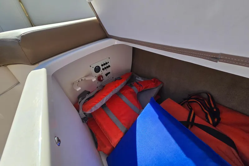 Slide: The Image of Storage compartment in 2014 Chaparral 246 SSi boat with life jackets and safety equipment. - 60