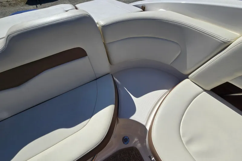 Slide: The Image of 2014 Chaparral 246 SSi boat interior with beige seating and brown accents. - 61
