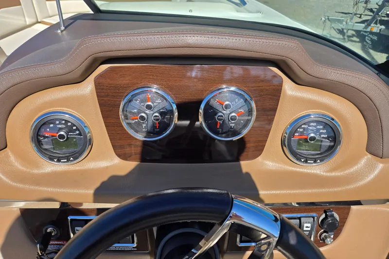 Slide: The Image of Dashboard of 2014 Chaparral 246 SSi boat with gauges and steering wheel. - 65