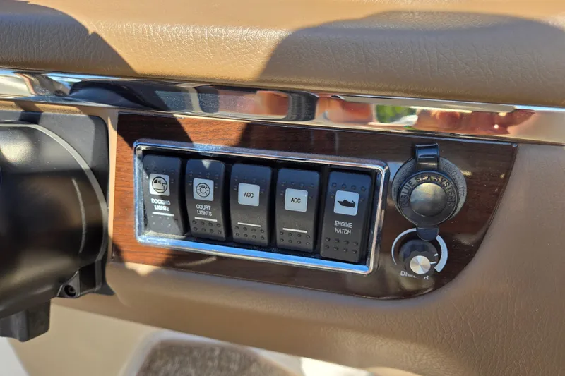 Slide: The Image of Dashboard controls of a 2014 Chaparral 246 SSi boat, featuring switches and ignition. - 66