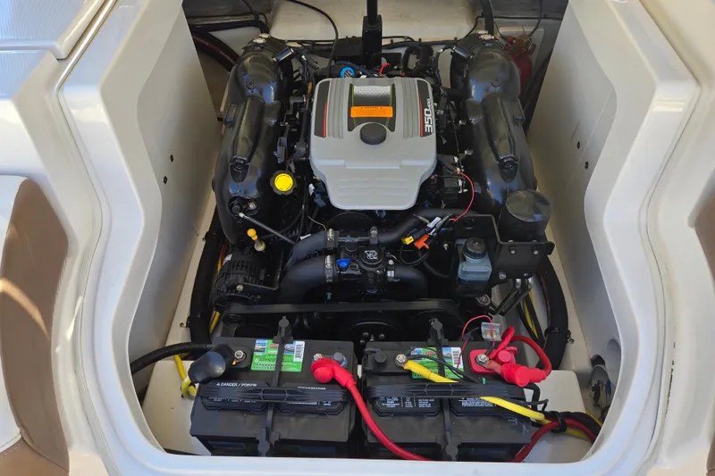 Slide: The Image of Engine compartment of a 2014 Chaparral 246 SSi boat, featuring a 350 engine and dual batteries. - 67