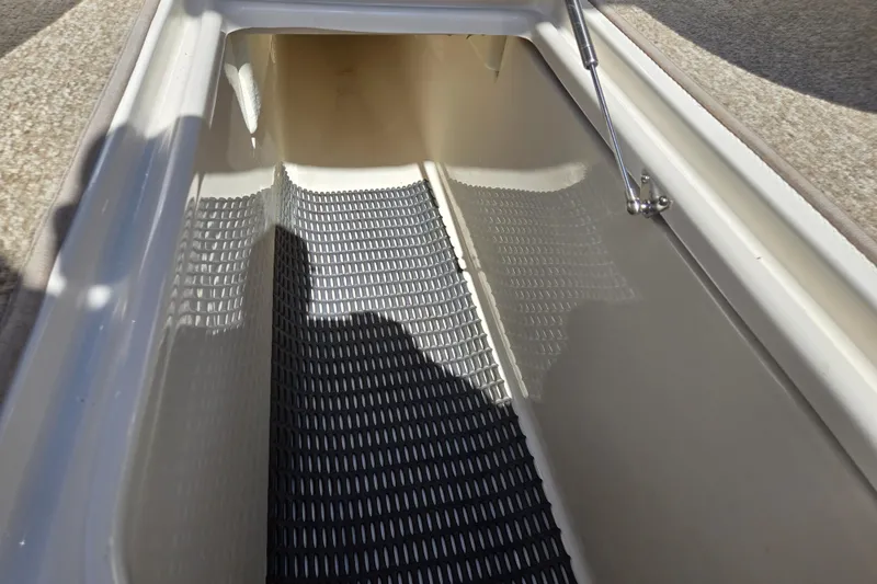 Slide: The Image of Storage compartment of a 2014 Chaparral 246 SSi boat with textured flooring. - 69