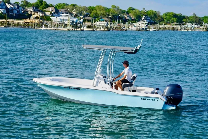 The Image of 2024 Tidewater 180 CC Adventure boat cruising on a scenic waterfront. - 0
