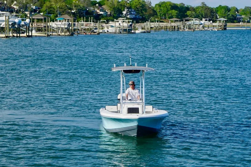 Slide: The Image of 2024 Tidewater 180 CC Adventure boat cruising on a scenic waterfront. - 10