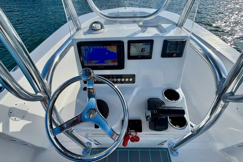 Slide: The Image of 2024 Tidewater 180 CC Adventure boat console with steering wheel and navigation displays. - 12
