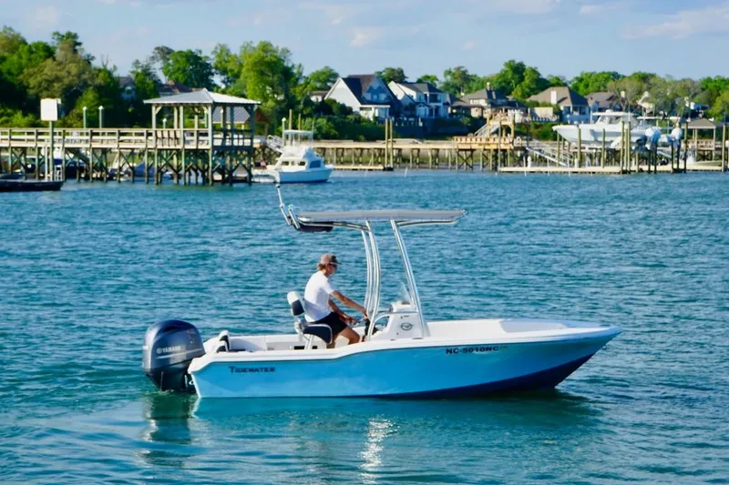 Slide: The Image of 2024 Tidewater 180 CC Adventure boat cruising on a scenic waterfront. - 3