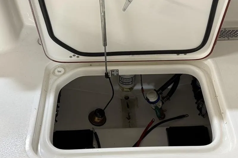 Slide: The Image of Open hatch of 2026 Sea Pro 242 Center Console boat, revealing internal components. - 10