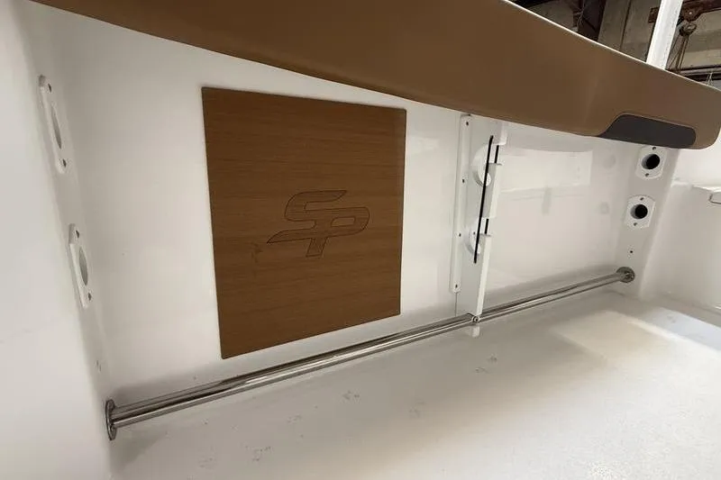 Slide: The Image of 2026 Sea Pro 242 Center Console interior detail with logo and stainless steel rail. - 11
