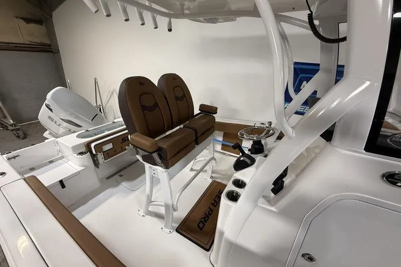 Slide: The Image of 2026 Sea Pro 242 Center Console boat interior with dual brown seats and modern controls. - 12