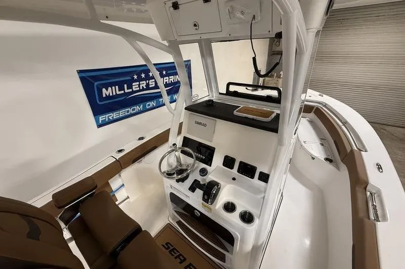 Slide: The Image of 2026 Sea Pro 242 Center Console boat interior with steering and controls. - 15