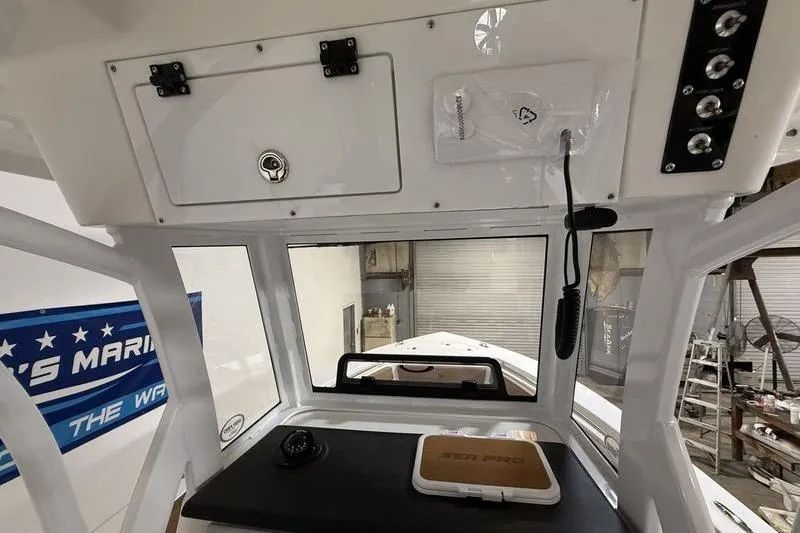 Slide: The Image of 2026 Sea Pro 242 Center Console interior with control panel and storage compartments. - 16