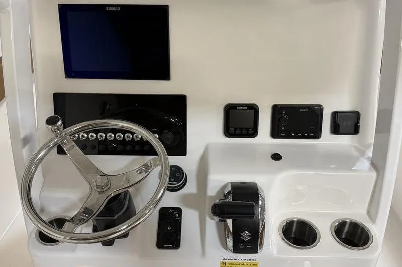 Slide: The Image of 2026 Sea Pro 242 Center Console dashboard with steering wheel and controls. - 18