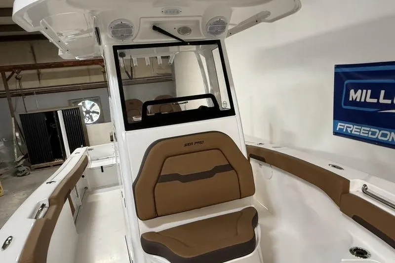 Slide: The Image of 2026 Sea Pro 242 Center Console boat interior with brown seating and modern design. - 24