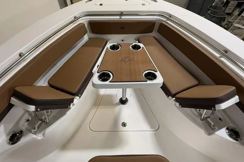 Slide: The Image of 2026 Sea Pro 242 Center Console boat interior with brown seating and table. - 25