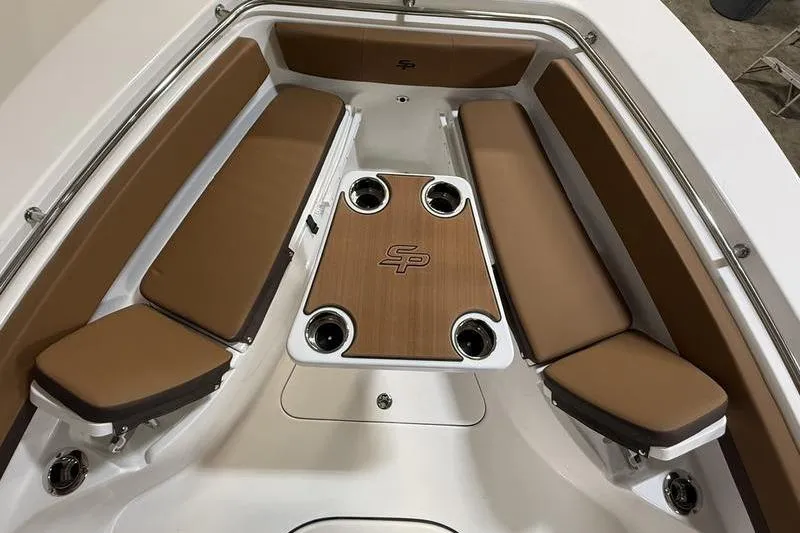 Slide: The Image of 2026 Sea Pro 242 Center Console boat interior with cushioned seating and table. - 26