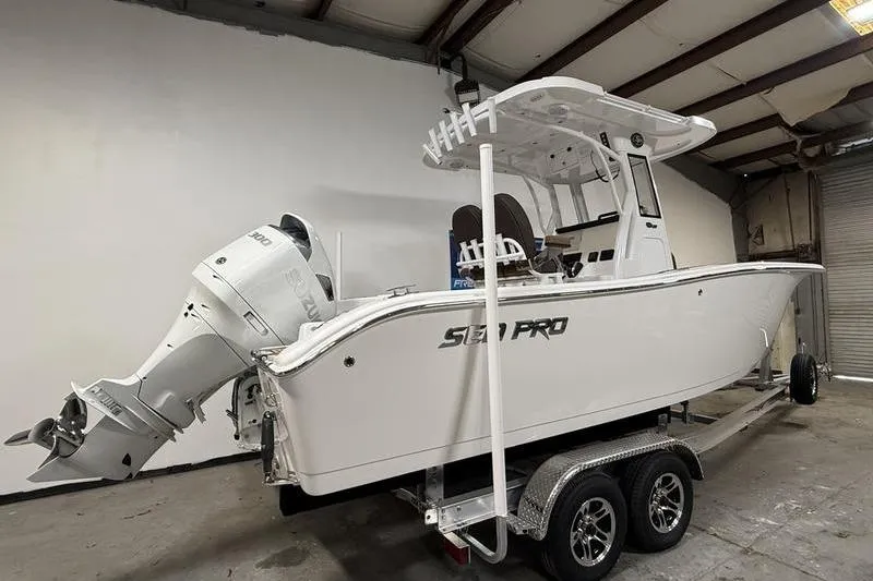 Slide: The Image of 2026 Sea Pro 242 Center Console boat on trailer in warehouse setting. - 3