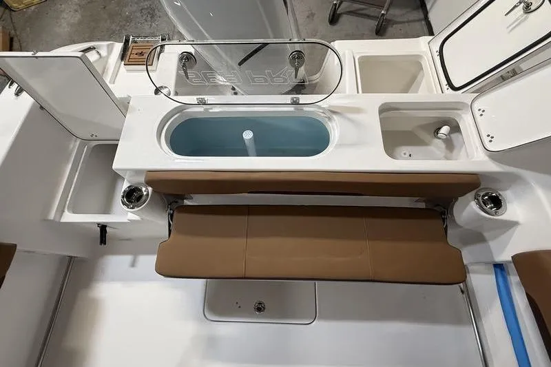 Slide: The Image of 2026 Sea Pro 242 Center Console boat interior with seating and storage compartments. - 7