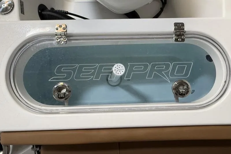 Slide: The Image of Livewell of 2026 Sea Pro 242 Center Console boat with clear lid and branding. - 8