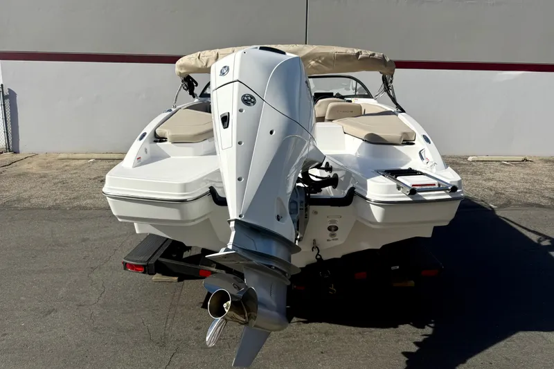 Slide: The Image of 2026 Tahoe 210 S boat with powerful outboard motor, parked on a trailer. - 12