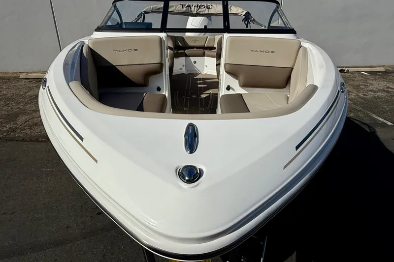 Slide: The Image of 2026 Tahoe 210 S boat with beige interior, viewed from the front. - 16
