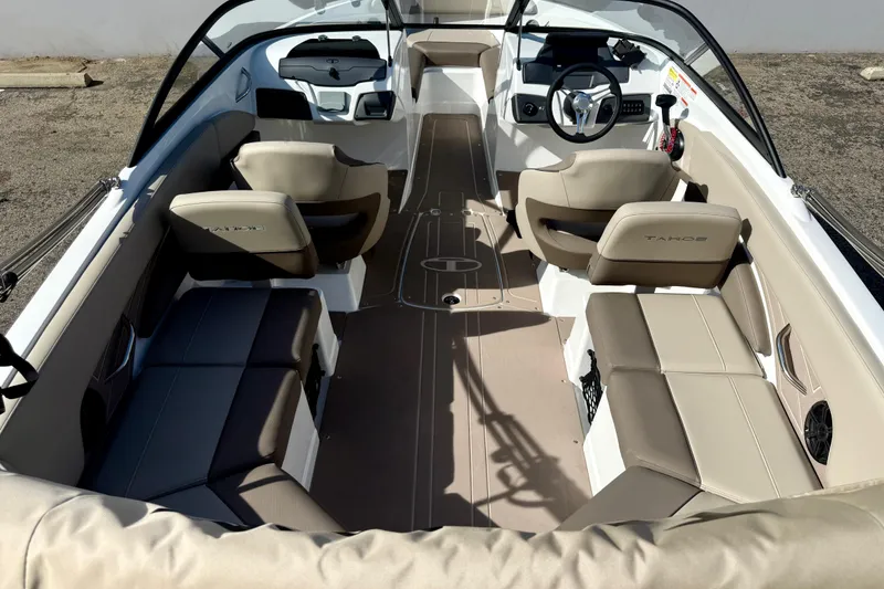Slide: The Image of Interior view of a 2026 Tahoe 210 S boat with beige seating and modern dashboard. - 21
