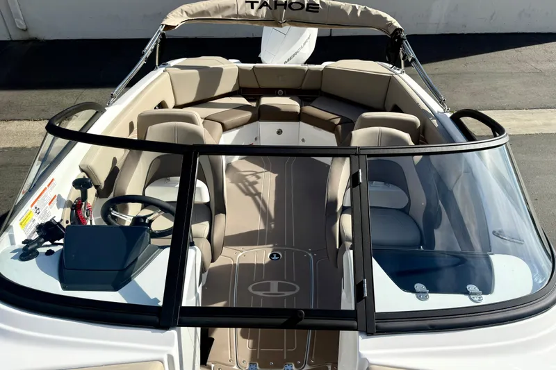 Slide: The Image of 2026 Tahoe 210 S boat interior with beige seating and sleek design. - 28