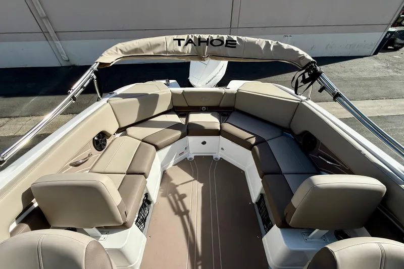 Slide: The Image of 2026 Tahoe 210 S boat interior with beige seating and sleek design. - 30