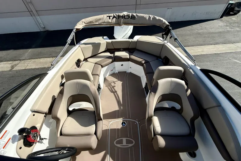 Slide: The Image of 2026 Tahoe 210 S boat interior with beige seating and steering wheel. - 31