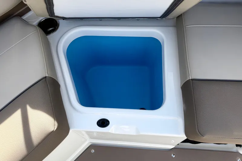 Slide: The Image of Storage compartment on 2026 Tahoe 210 S boat, featuring blue interior and beige seating. - 33