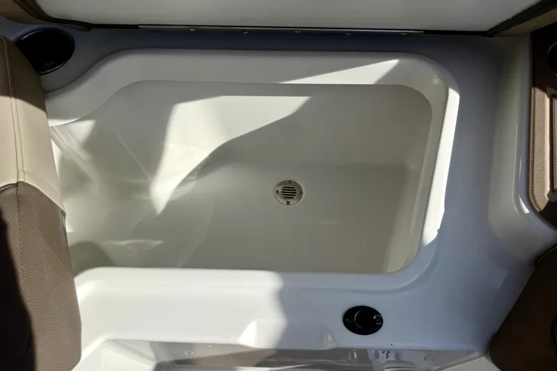 Slide: The Image of Interior view of 2026 Tahoe 210 S boat's storage compartment with drain. - 34
