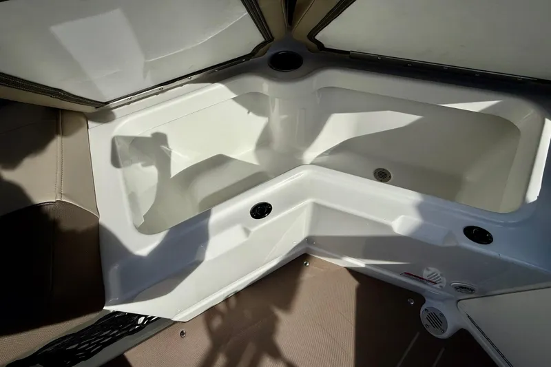 Slide: The Image of Interior view of 2026 Tahoe 210 S boat, featuring a spacious storage compartment. - 36