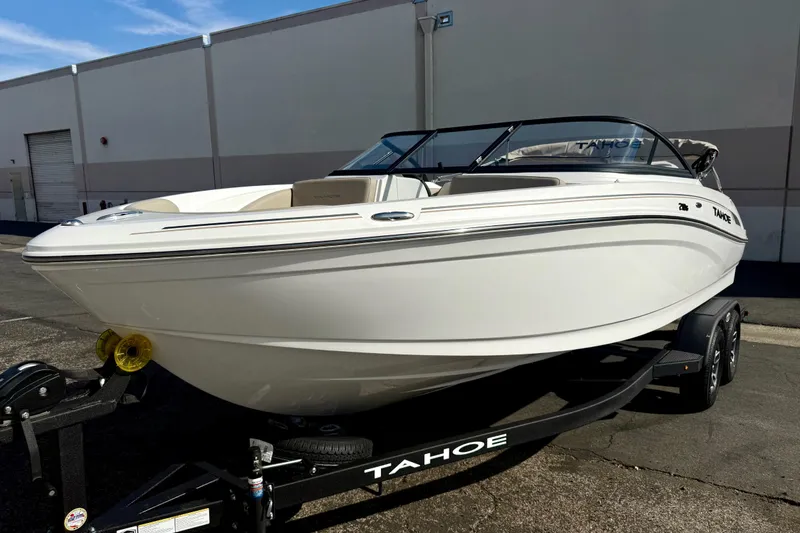 Slide: The Image of 2026 Tahoe 210 S boat on trailer, parked outdoors, showcasing sleek design and modern features. - 8