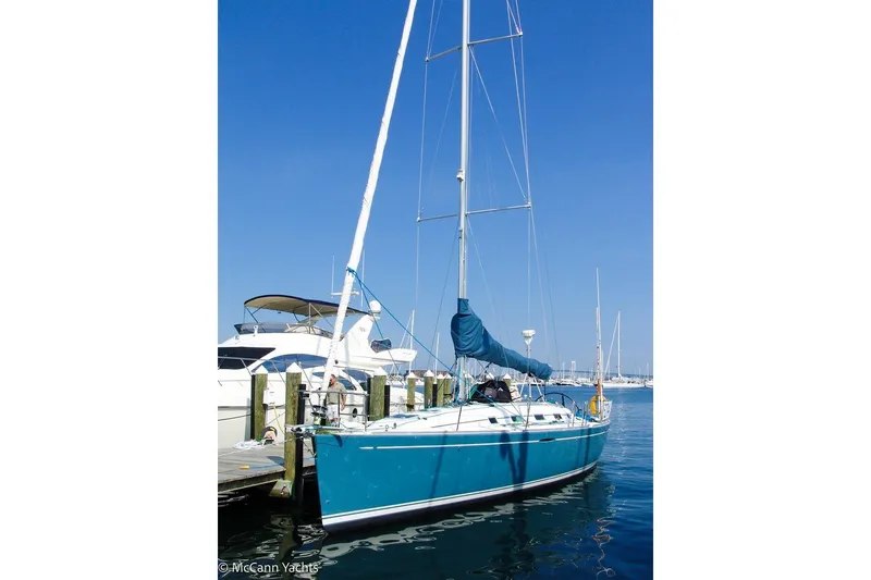 Slide: The Image of 2005 Beneteau First 44.7 sailboat docked at marina under clear blue sky. - 10