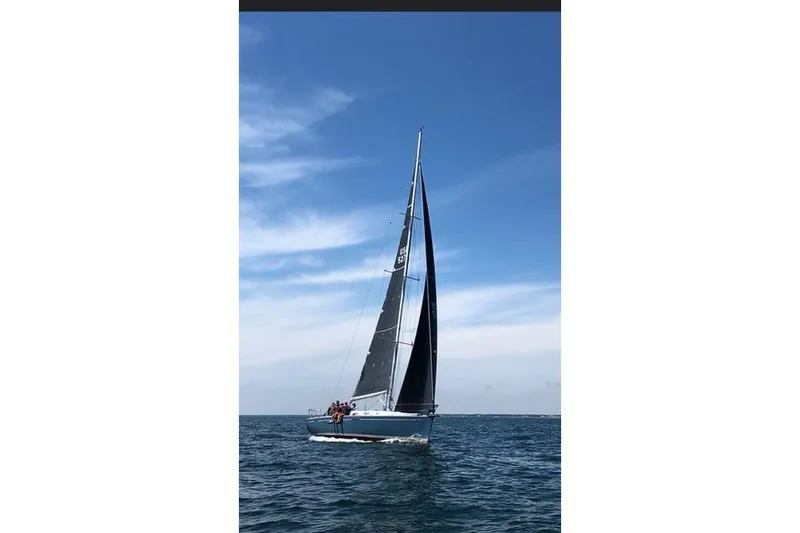Slide: The Image of Sailing yacht Beneteau First 44.7 (2005) gliding on open sea under clear blue sky. - 11
