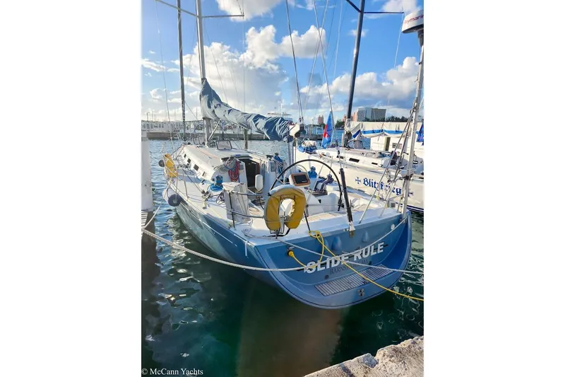 Slide: The Image of 2005 Beneteau First 44.7 sailboat docked in a sunny marina. - 12