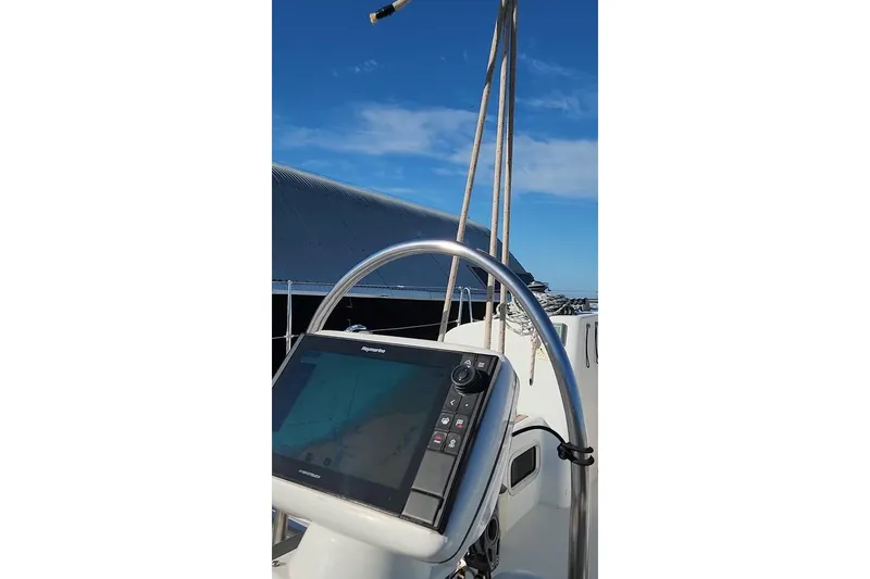 Slide: The Image of Beneteau First 44.7 yacht helm with navigation system, 2005 model, under clear blue sky. - 19
